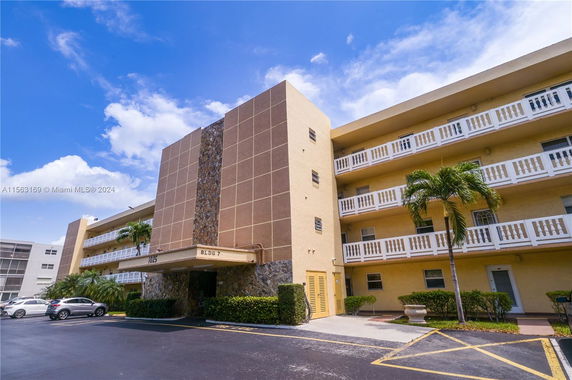 Front view of a multi-story residential building with balconies.
