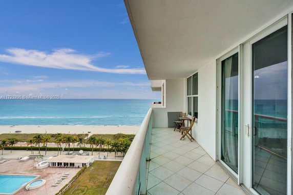 Balcony view overlooking a beach and ocean.