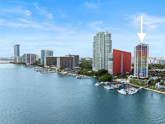 Wide view of waterfront buildings and marina area.