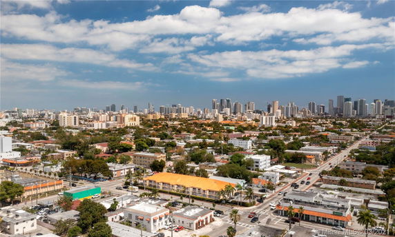 Panoramic view of a cityscape with various buildings and a skyline in the distance.