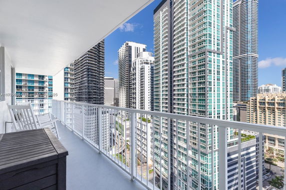 Panoramic view of high-rise buildings from a balcony.