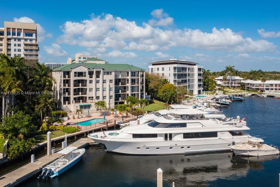 View of waterfront buildings with boats docked along a canal.
