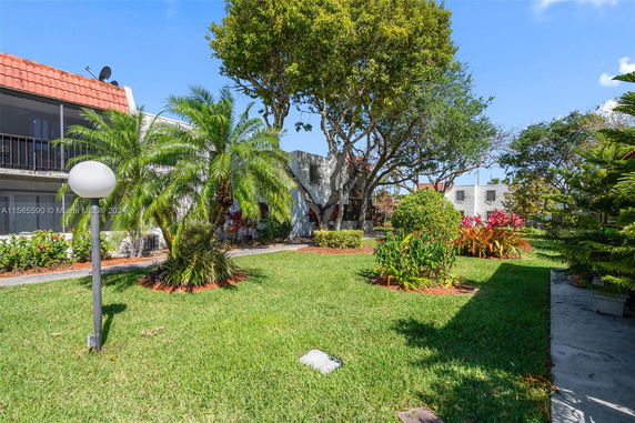 View of landscaping with trees and bushes in a residential area.
