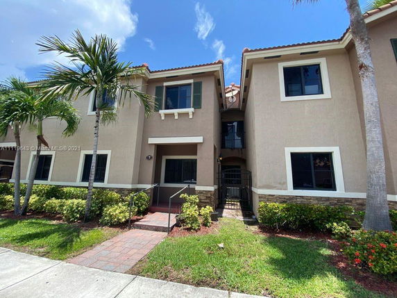 Front view of a two-story townhouse with landscaping.