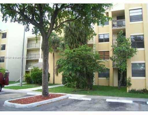 Front view of a multi-story apartment building with balconies.