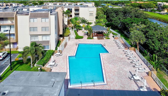 Outdoor swimming pool area with surrounding buildings.