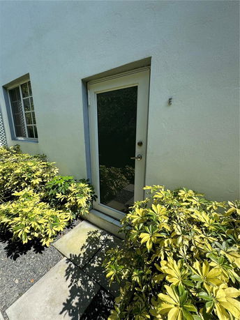 Side view of a house with a glass door and window.