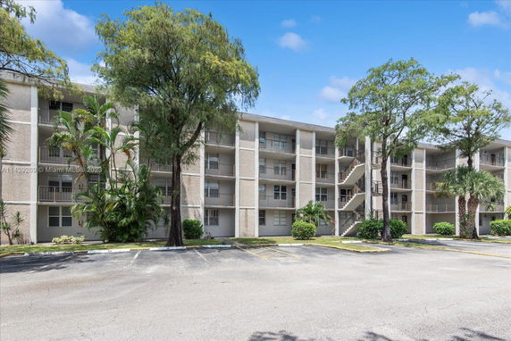 Front view of a multi-story apartment building with balconies.