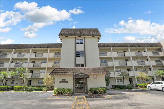 Front view of a multi-story residential building with balconies.