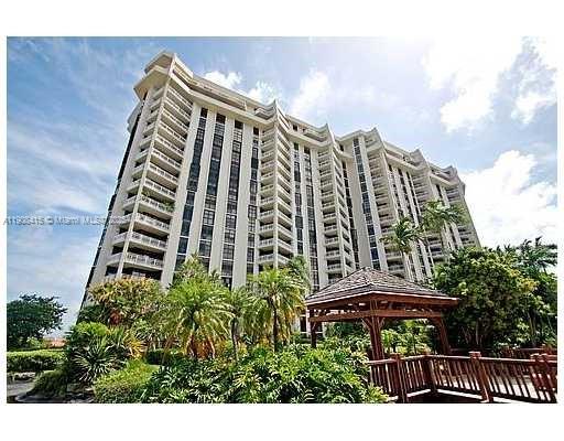 Front view of a high-rise building with multiple floors and balconies.