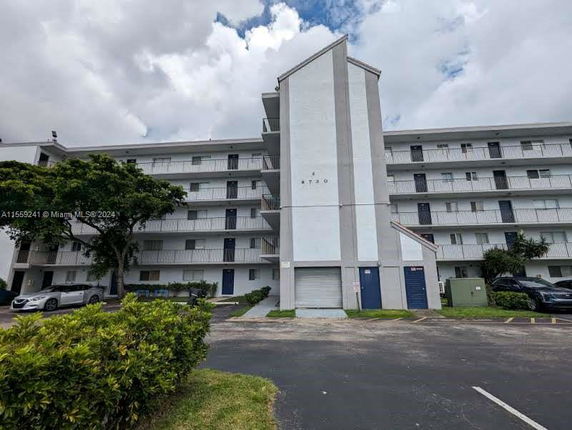 Front view of a multi-story residential building with balconies.