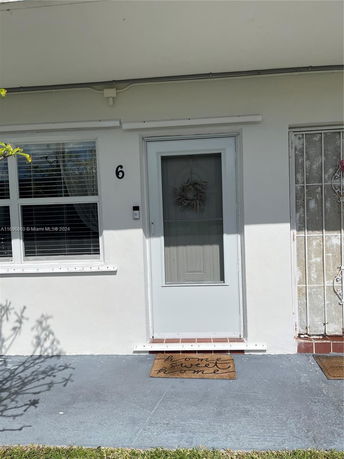 Front view of a house entrance with a door and window.