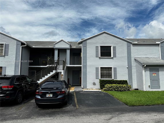 Front view of a two-story residential building with multiple units.