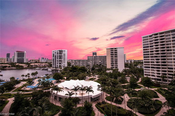Panoramic view of high-rise buildings with a vibrant sunset sky and surrounding area.