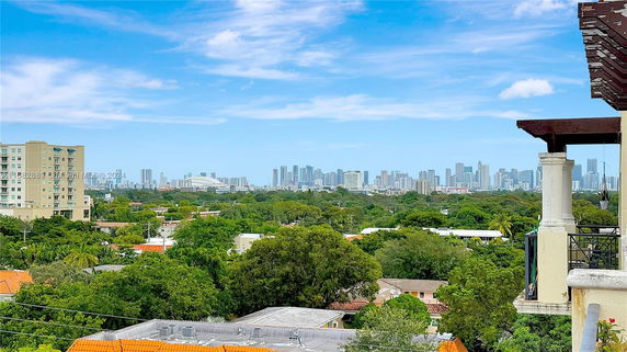 Panoramic view of city skyline from a building rooftop.