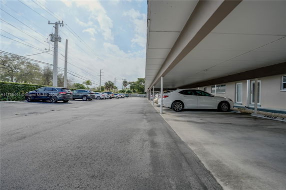 Outdoor parking area with covered parking spaces.