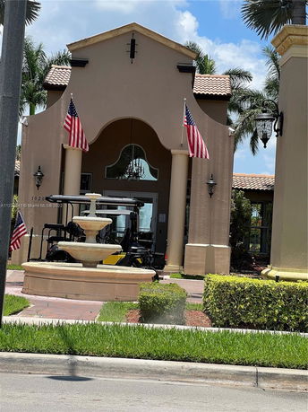 Front view of a building with columns and flags.