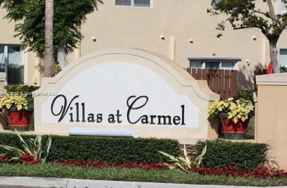 Front view of a building with a sign reading 'Villas at Carmel'.