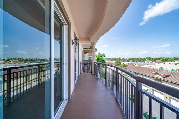 Balcony view overlooking surrounding buildings and landscape.