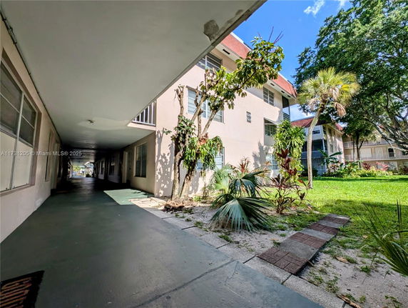 Front view of a multifamily residential building with a walkway.
