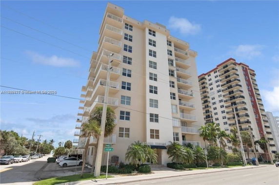 Front view of a multi-story residential building with balconies.