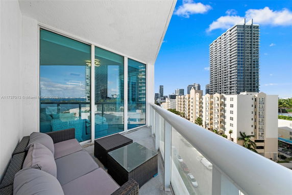 View from a balcony overlooking nearby high-rise buildings.