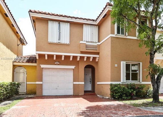 Front view of a two-story house with a garage.