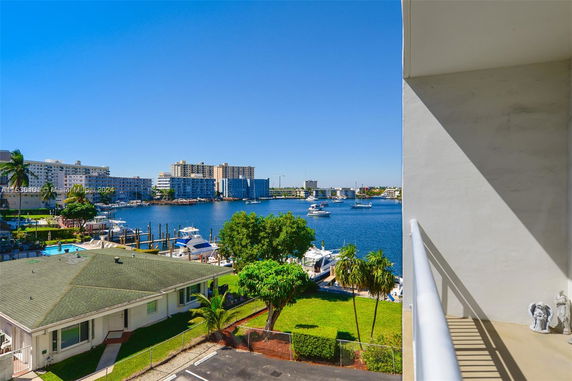 View of waterfront area with buildings and boats on a sunny day.