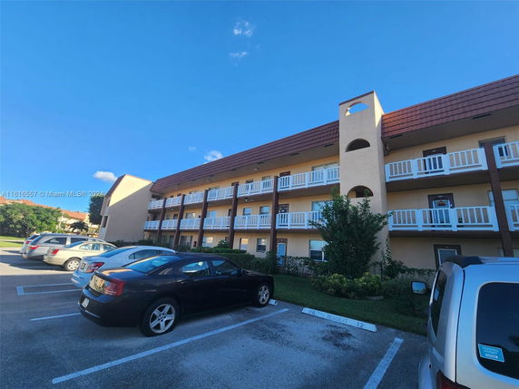 Front view of a multi-story building with balconies.