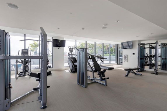 Interior view of a gym with exercise machines and equipment.