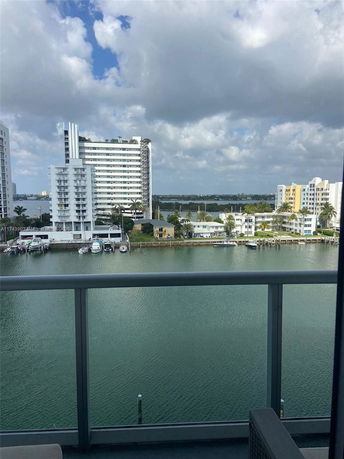 Panoramic view from a building overlooking water and nearby structures.