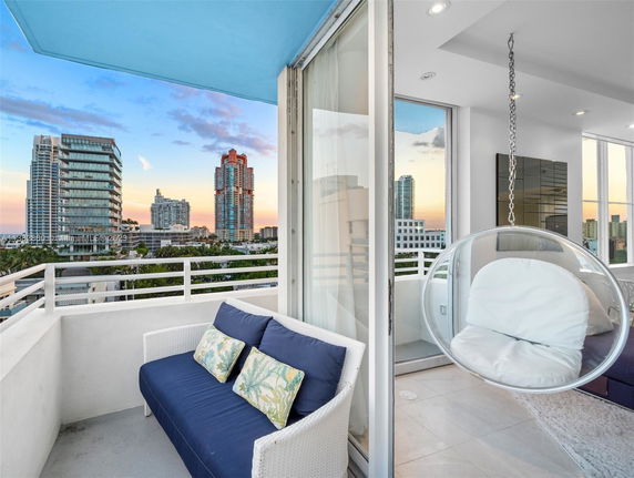 Balcony view overlooking cityscape with high-rise buildings.