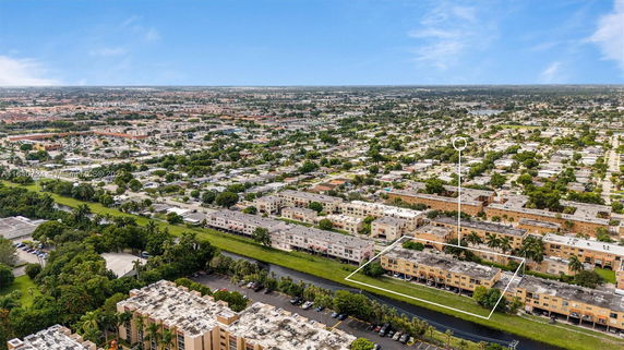 Panoramic view of a residential area with multiple buildings and surrounding greenery.