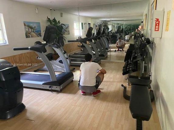 Indoor gym area with exercise equipment and mirrors.