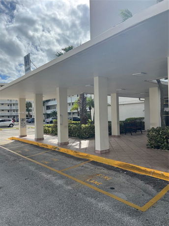 Front view of a building with a covered walkway supported by columns.