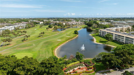 Aerial view of a landscaped area with water features, buildings, and greenery.