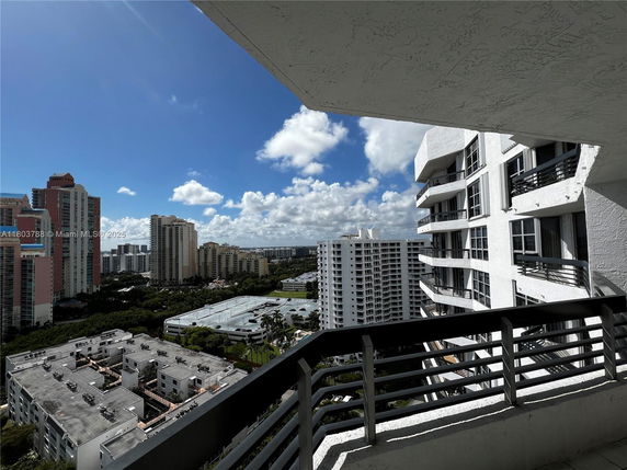 Panoramic view of a cityscape with high-rise buildings under a blue sky.