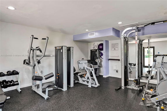 Indoor gym area with various exercise equipment.