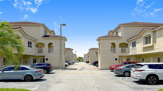 Outdoor parking area surrounded by multi-story residential buildings