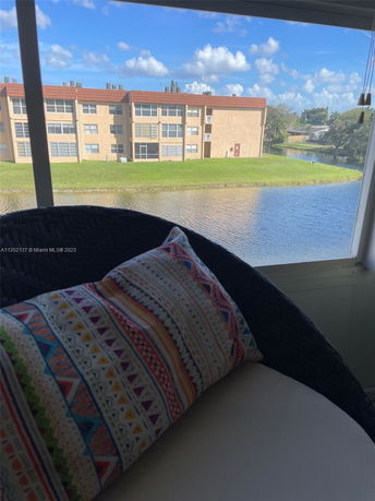 View from a building showing neighboring apartment complex by a water body.