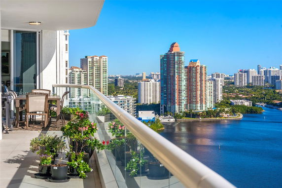 Panoramic view of cityscape and waterfront from a balcony.