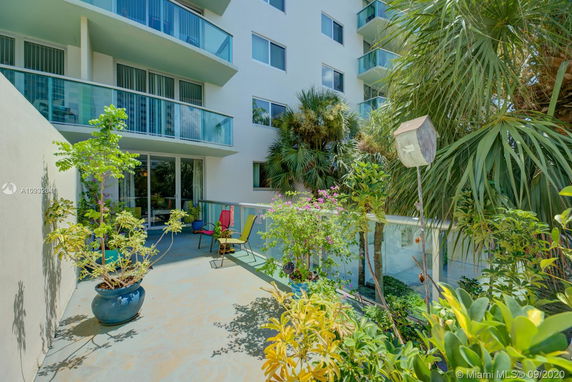 Exterior view of a multi-story building with balconies and glass railings.