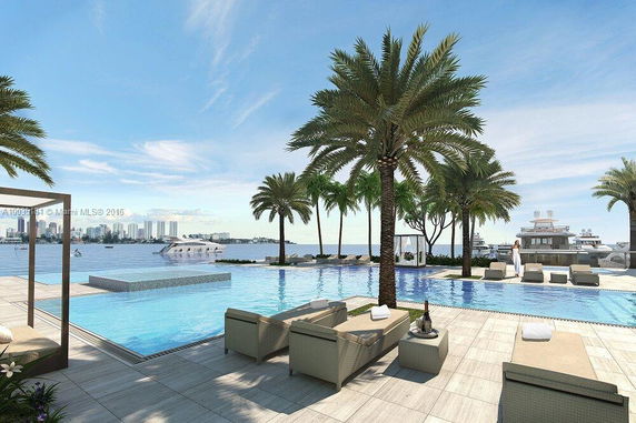 Outdoor area with a pool, palm trees, and a view of a waterfront with yachts and city skyline in the background.