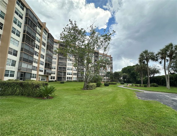 Front view of a multi-story apartment building with balconies.