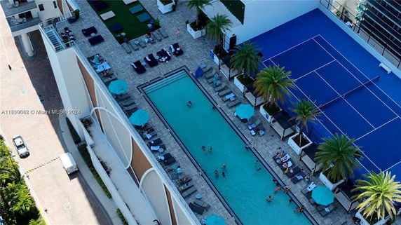 Rooftop featuring a swimming pool, lounge area, and tennis court.
