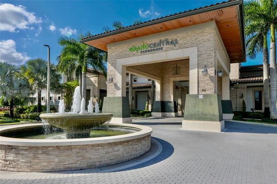 Front view of the Grand Central Club House with a water fountain.