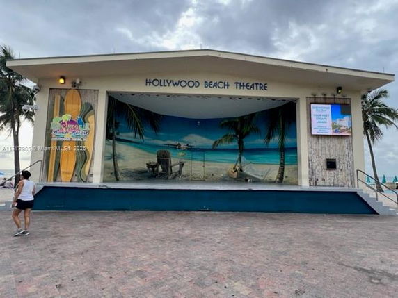 Front view of the Hollywood Beach Theatre with a mural of a beach scene on the stage.