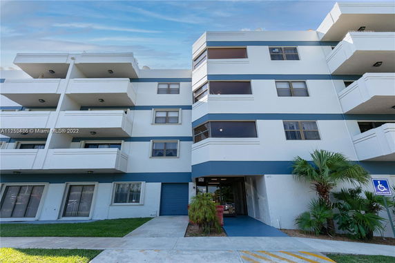 Front view of a multi-story building with balconies.