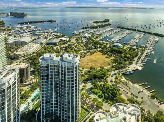 High-rise buildings with marina and waterfront view.
