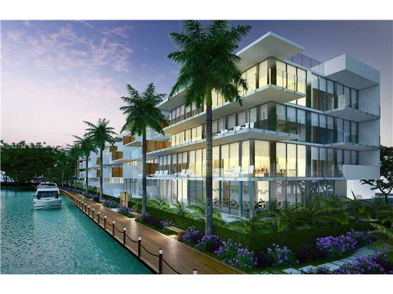 Front view of a modern multi-story waterfront building with large windows and balconies.